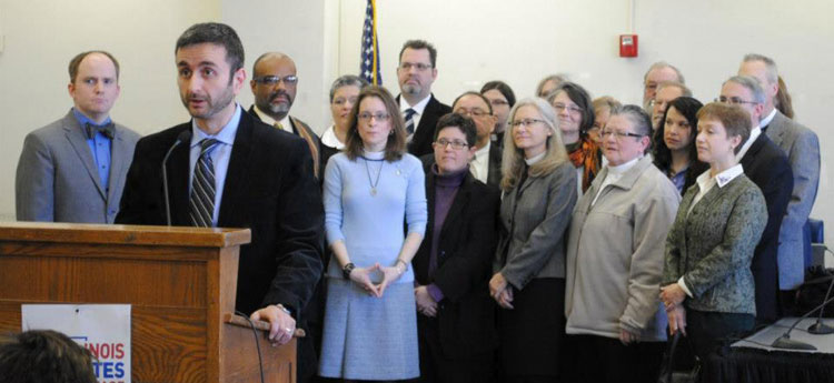Recently released LDS Bishop Kevin Kloosterman (background, right from flag) participated with other people of faith in an event in support of HB5170